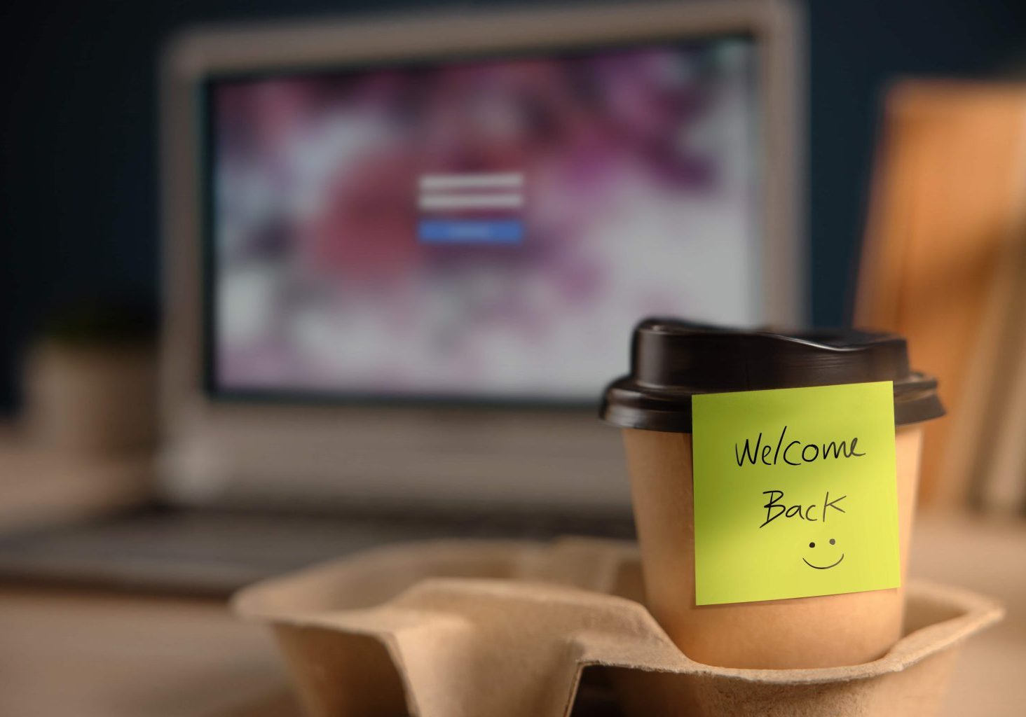Back to Work Concept. Closeup of Welcome Note on Takeaway Coffee Cup in Office Desk. Message from a Colleague or Boss